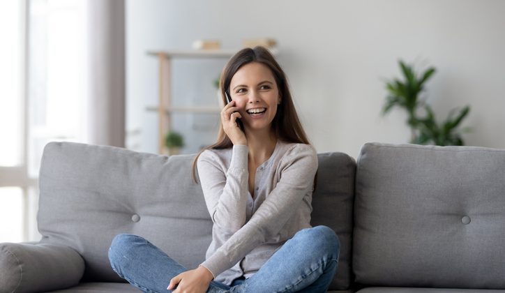 A young women is making an international call while setting in comfort