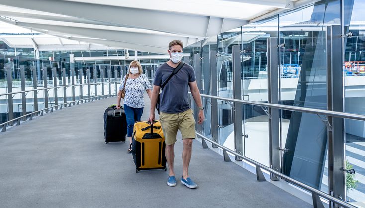 A senior women with her son just at the airport wearing mask because of COVID 19