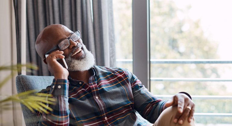 An African Man in his early 50s Calling home from abroad