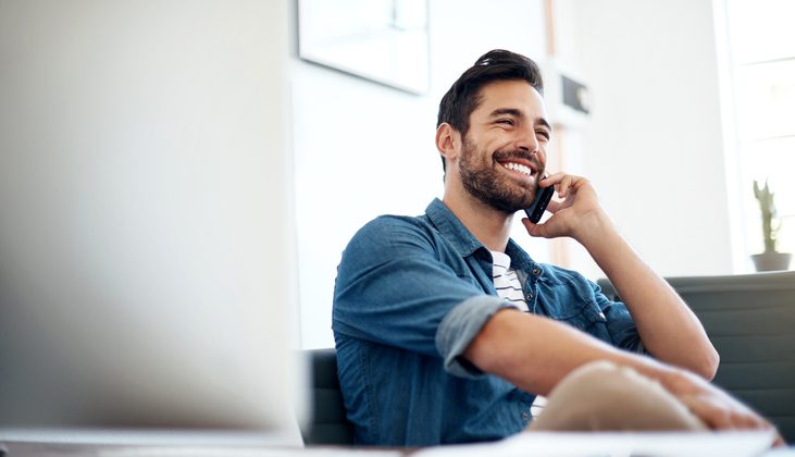 A young man using the best voip app to make an international call