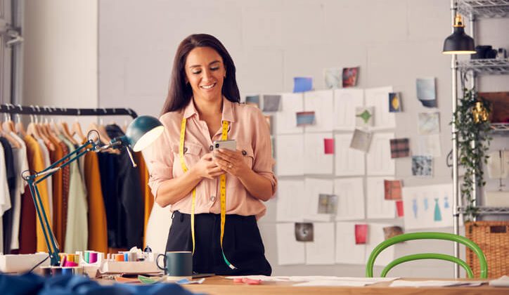 A Young business women sending business texts to her customers
