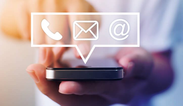 Close-up image of male hands using smartphone with icon telephone email mobile phone and address