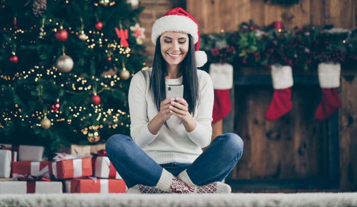 A women in Christmas costume reading Christmas messages