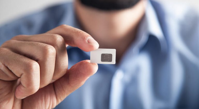 Male hand holding Sim card with sim only deals package