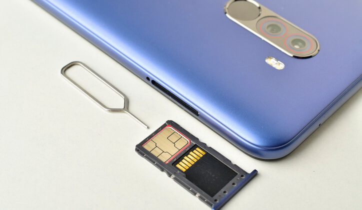 data Sim card and memory card in sim tray with smartphone and sim ejector pin isolated on white background