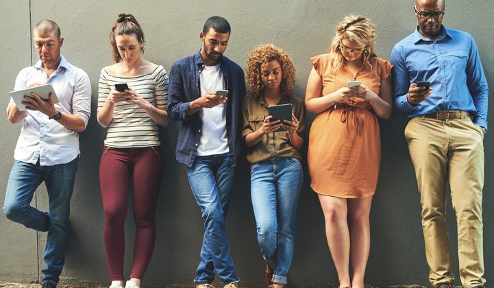 Shot of a diverse group of people social networking outside