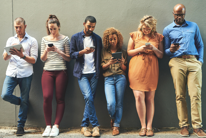 Shot of a diverse group of people social networking outside